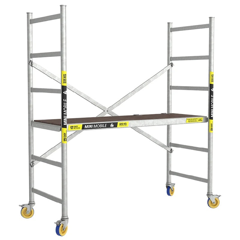 A silver aluminum mini scaffolding system with a wooden platform, yellow and black branded vertical sections, and caster wheels, shown on a plain white background.