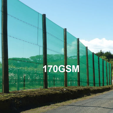 A green 170GSM mesh fence installed along a roadside